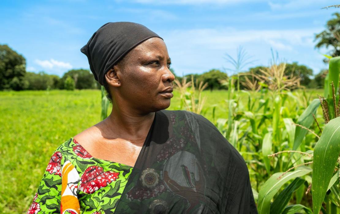 Photo: UNDP Burkina Faso A woman standing in a field looking far away in Burkina Faso